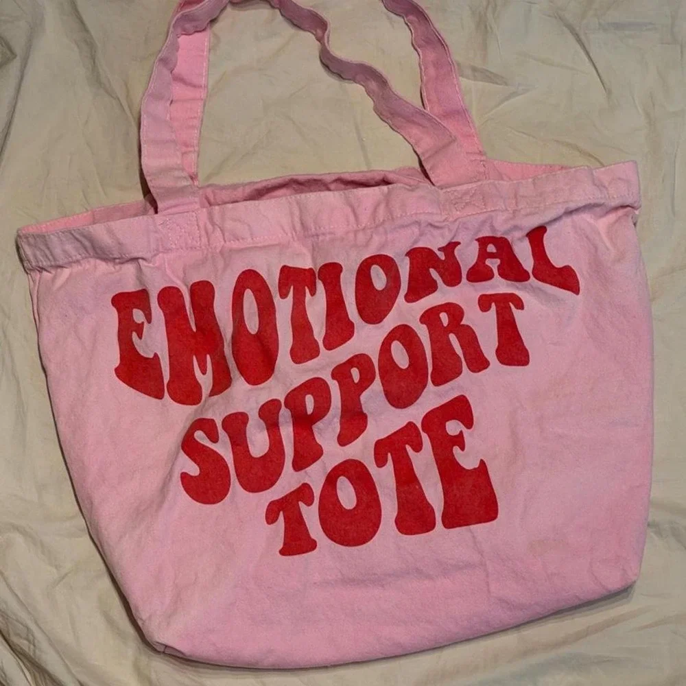 Pink tote bag with red text